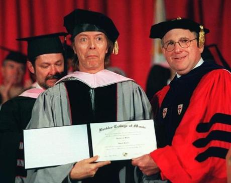 David Bowie mugs upon receiving his honorary degree from Beklee College of Music president Lee Eliot Berk in 1999.
